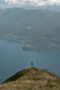 High angle view of young woman standing on mountain