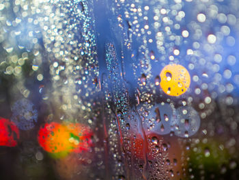 Close-up of wet glass window in rainy season