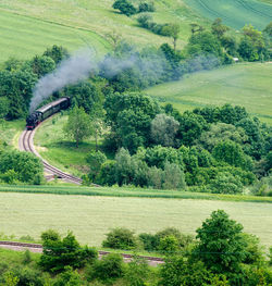 Steaming engine in green delicious scenery in the black forest