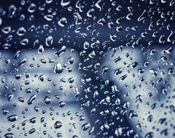 Full frame shot of raindrops on glass window