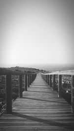 Pier over sea against clear sky