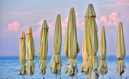 Sun umbrellas on the beach on sunset background in sopot