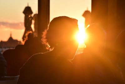 Man and woman in city during sunset