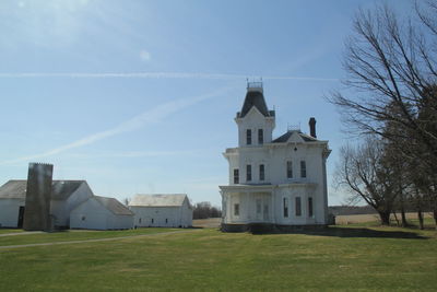 Houses on field against sky