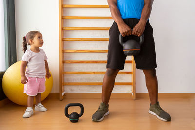 Side view of woman exercising on floor