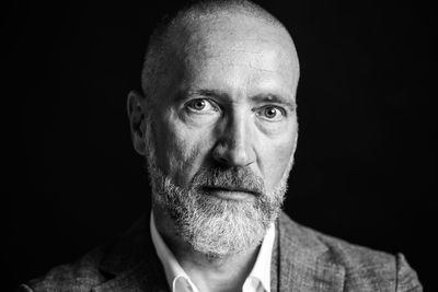 Close-up portrait of man on black background