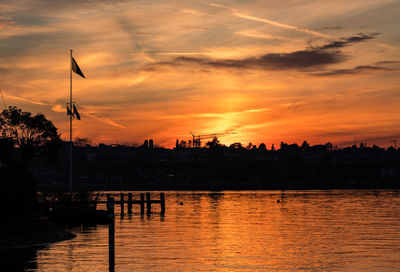 Scenic view of river against orange sky