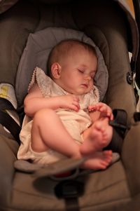 Portrait of little baby girl sleeping in baby stroller