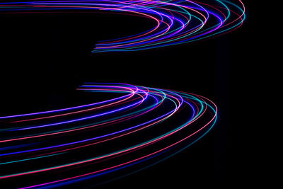 Digital composite image of light painting against black background