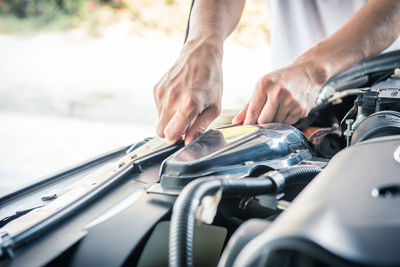 Auto mechanic checking car engine,worker selective focus