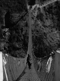 High angle view of man walking on bridge