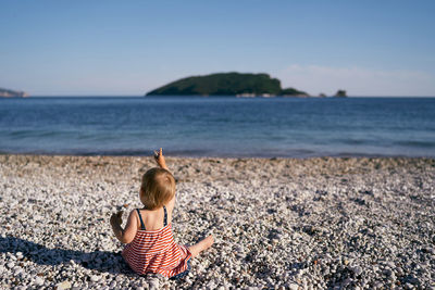 Rear view of boy on beach