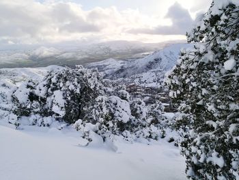 Scenic view of snow covered mountains against sky