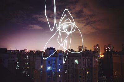 Low angle view of illuminated buildings at night