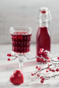 Red cocktail, vodka or liqueur and heart shape decorations