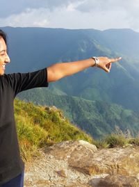 Midsection of man standing on mountain against sky