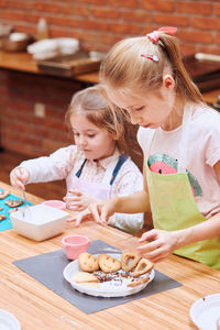 Mother and daughter on table