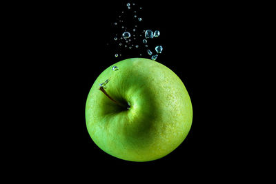 Close-up of apple against black background