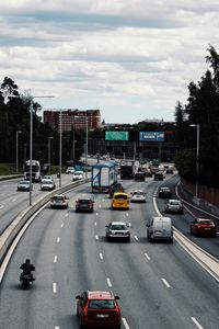 Traffic on road in city against sky