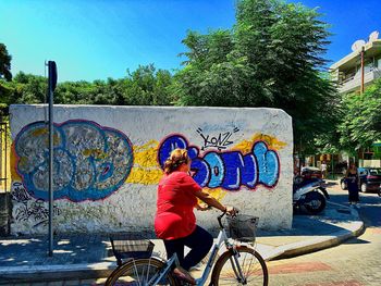 Woman with bicycle on street in city