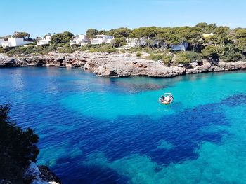 High angle view of rocks by sea against sky, cala d'or, mallorca, spain