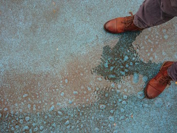 Low section of man standing on street