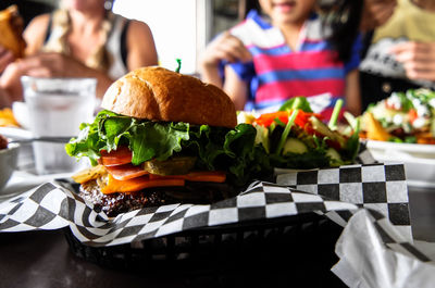 Close-up of food on table with people in background