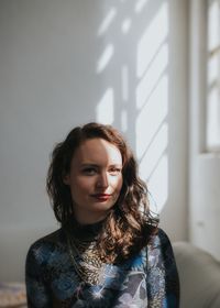 Portrait of young woman at home