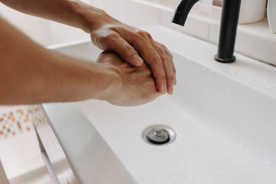 High angle view of hands in bathroom