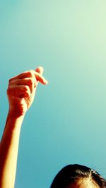 Cropped image of woman against clear blue sky