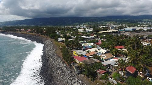 High angle view of townscape by sea against sky