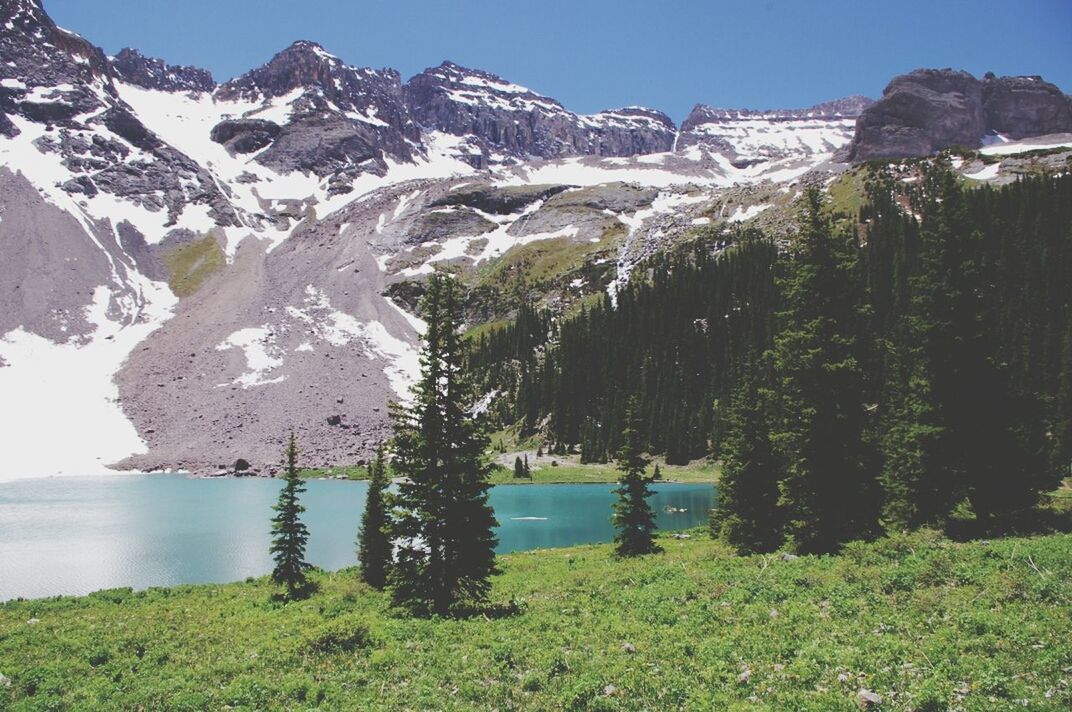 mountain, water, tranquil scene, tranquility, scenics, beauty in nature, nature, lake, mountain range, grass, clear sky, snow, winter, blue, idyllic, non-urban scene, cold temperature, sky, day, river