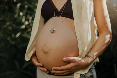 Midsection of woman touching head