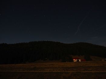 Scenic view of field against sky at night