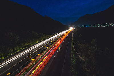 High angle view of light trails on road at night