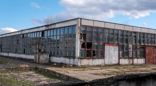 Abandoned factory warehouse with broken windows