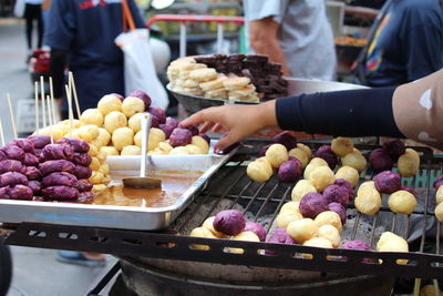 Midsection of man preparing food at market