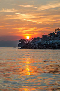 Scenic view of sea against orange sky