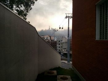 Buildings in city against cloudy sky