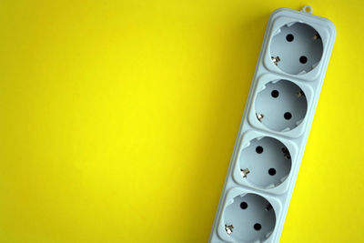 Close-up of audio equipment on yellow background