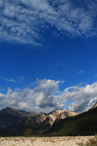 Scenic view of mountains against blue sky