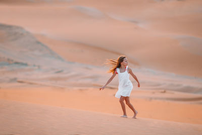 Full length of woman standing on beach