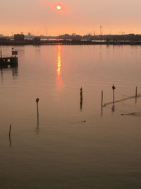 Scenic view of lake against sky during sunset