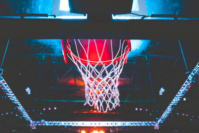 Low angle view of basketball hoop at night