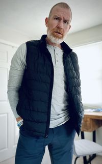 Portrait of man standing against wall