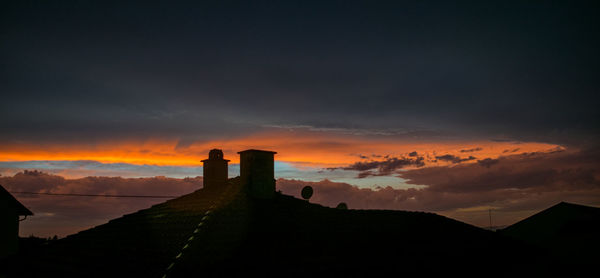Silhouette building against sky during sunset