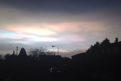 Silhouette of trees against cloudy sky