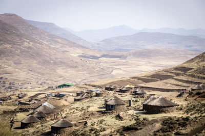 High angle view of traditional village landscape and mountains against sky in lesotho