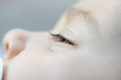 Close-up of cute baby girl with teardrop on face