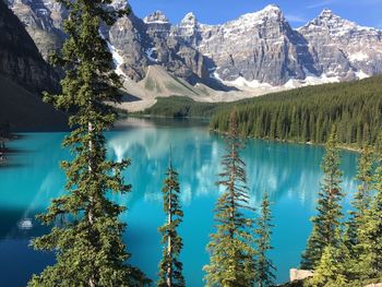 Scenic view of lake and mountains against blue sky